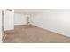 Open-concept living room with neutral carpeting and arched doorways at 6608 S Willow Dr, Tempe, AZ 85283