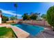 Sparkling pool with updated tile, surrounded by lush greenery and desert landscaping at 6608 S Willow Dr, Tempe, AZ 85283