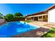 Sparkling pool in backyard with covered patio and outdoor kitchen area at 6608 S Willow Dr, Tempe, AZ 85283