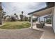 This beautiful backyard features a covered patio with comfortable seating, a lush lawn and mature palm trees at 8755 E Gary Rd, Scottsdale, AZ 85260