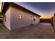 Back of the house featuring clean lines, a covered patio, manicured lawn, and access to a private fenced yard at 8755 E Gary Rd, Scottsdale, AZ 85260