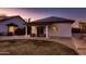 Back of the house with a covered patio, seating, and a lush lawn extending to the fence-line at 8755 E Gary Rd, Scottsdale, AZ 85260