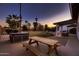 A desert landscaped backyard features a picnic table and hot tub, offering an ideal space for relaxation and outdoor dining at 8755 E Gary Rd, Scottsdale, AZ 85260