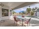 Covered patio with dining table and chairs offers a perfect spot for outdoor meals overlooking the pool and backyard at 8755 E Gary Rd, Scottsdale, AZ 85260