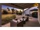 Covered backyard patio with seating overlooking a lush lawn and landscaping perfect for relaxing or entertaining guests at 8755 E Gary Rd, Scottsdale, AZ 85260