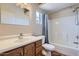 This bathroom features a wood vanity with sink, toilet, bathtub, and shower, all illuminated by a window at 8755 E Gary Rd, Scottsdale, AZ 85260