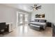 Modern bedroom with ensuite access to pool, a ceiling fan, and minimalist decor at 8755 E Gary Rd, Scottsdale, AZ 85260