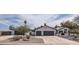 Charming single-story home featuring a three car garage and desert landscaping at 8755 E Gary Rd, Scottsdale, AZ 85260