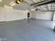 Bright garage with epoxy floor, shelving, and access to storage at 8755 E Gary Rd, Scottsdale, AZ 85260