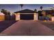 A spacious garage with a concrete driveway provides ample parking and curb appeal, complemented by desert landscaping at 8755 E Gary Rd, Scottsdale, AZ 85260