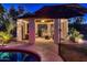 Cozy outdoor gazebo with stylish furniture offering relaxation by the inviting backyard pool at dusk at 8755 E Gary Rd, Scottsdale, AZ 85260
