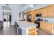 The open kitchen has a large island with seating, stainless steel appliances, and light wood cabinetry at 8755 E Gary Rd, Scottsdale, AZ 85260