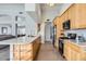 Bright kitchen features an island with seating, stainless steel appliances, light wood cabinets, and concrete floors at 8755 E Gary Rd, Scottsdale, AZ 85260