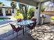 Covered patio with dining table, outdoor grill, and views of the pool and landscaped yard at 8755 E Gary Rd, Scottsdale, AZ 85260