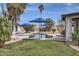 Landscaped backyard boasts a sparkling pool, sun loungers, and lush greenery, creating a private oasis at 8755 E Gary Rd, Scottsdale, AZ 85260