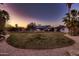 Large, well-maintained lawn surrounds a beautiful single Gathering home at sunset, offering ample space at 8755 E Gary Rd, Scottsdale, AZ 85260