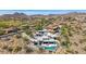 Contemporary home featuring a geometric roofline, stone accents, outdoor pool, lounge area, and desert landscape at 9127 N Fireridge Trl, Fountain Hills, AZ 85268