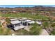 Stunning aerial view of modern home with stone accents, lush landscaping, and golf course views at 9127 N Fireridge Trl, Fountain Hills, AZ 85268