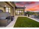 Lush backyard featuring artificial turf, comfortable seating, and seamless access to the home's interior at 9127 N Fireridge Trl, Fountain Hills, AZ 85268