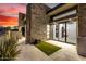 Outdoor patio with an artificial turf area, stone facade and views into the home at 9127 N Fireridge Trl, Fountain Hills, AZ 85268