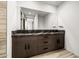 Bathroom vanity featuring black countertops and natural wood cabinets and drawers at 9127 N Fireridge Trl, Fountain Hills, AZ 85268