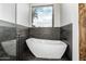 Sleek bathroom showcasing a freestanding tub and stylish fixtures by a bright window at 9127 N Fireridge Trl, Fountain Hills, AZ 85268