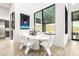 Bright dining room features floor-to-ceiling windows with views, a modern table, and stylish seating at 9127 N Fireridge Trl, Fountain Hills, AZ 85268