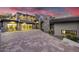 Modern home featuring stone accents, a glass garage door, and a spacious driveway at 9127 N Fireridge Trl, Fountain Hills, AZ 85268