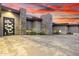 Modern home featuring stone accents, desert landscaping, and a decorative front door at 9127 N Fireridge Trl, Fountain Hills, AZ 85268