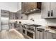 Modern kitchen features stainless steel appliances, pot filler, white subway tile, and granite countertops at 9127 N Fireridge Trl, Fountain Hills, AZ 85268