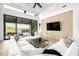 Bright living room boasts a modern ceiling fan, large sectional couch, and sliding glass doors to a covered patio at 9127 N Fireridge Trl, Fountain Hills, AZ 85268