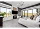 Bright main bedroom featuring a ceiling fan, desert views, and a seating area at 9127 N Fireridge Trl, Fountain Hills, AZ 85268