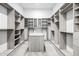 Large walk-in closet with custom shelving and a central island for storage at 9127 N Fireridge Trl, Fountain Hills, AZ 85268
