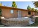 A charming back patio with brick enclosure, and a secure door, offering a private outdoor space at 15462 N Lakeforest Dr, Sun City, AZ 85351