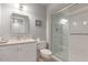 Bright bathroom featuring a glass door shower, granite countertops, and a neutral color palette at 15462 N Lakeforest Dr, Sun City, AZ 85351