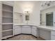 Bright bathroom with white cabinetry, large mirrors and vanity lighting at 15462 N Lakeforest Dr, Sun City, AZ 85351
