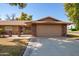 Single-story home featuring a brick facade, two-car garage, and well-maintained landscaping at 15462 N Lakeforest Dr, Sun City, AZ 85351