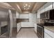 Modern kitchen with stainless steel appliances, tile backsplash, and white cabinetry at 15462 N Lakeforest Dr, Sun City, AZ 85351