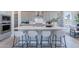 Modern kitchen featuring a central island with bar stool seating and sleek, gray cabinetry at 17894 W Hood River Rd, Surprise, AZ 85388