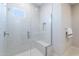Walk-in shower with sleek glass enclosure, bench, and modern fixtures at 17894 W Hood River Rd, Surprise, AZ 85388