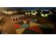 Backyard with a chessboard and vibrant art is lit up at night at 1932 E Beck Ln, Phoenix, AZ 85022