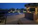 Inviting backyard with a game area, outdoor kitchen, manicured landscaping, and city views at 1932 E Beck Ln, Phoenix, AZ 85022