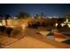 Backyard with manicured landscaping, outdoor seating, colorful art, and city views at 1932 E Beck Ln, Phoenix, AZ 85022