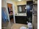 Bathroom features a vanity with granite counters and dark cabinets, and an open door to the bedroom at 1932 E Beck Ln, Phoenix, AZ 85022