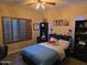 Bedroom has neutral paint, and dark furniture illuminated with blue ambient lighting at 1932 E Beck Ln, Phoenix, AZ 85022