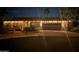 An expansive home exterior is decorated with seasonal holiday lighting at night at 1932 E Beck Ln, Phoenix, AZ 85022