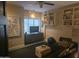A modern gym features a wall-mounted TV, shelves, seating, and space for a workout at 1932 E Beck Ln, Phoenix, AZ 85022