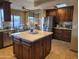 Gourmet kitchen with granite countertops, a central island, custom cabinets and stainless steel appliances at 1932 E Beck Ln, Phoenix, AZ 85022