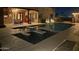 Backyard with a pool and spa has views of the house at night at 1932 E Beck Ln, Phoenix, AZ 85022