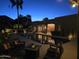 Inviting backyard pool area with relaxing patio seating, lush palm trees, and scenic lighting at 1932 E Beck Ln, Phoenix, AZ 85022